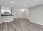 Thumbnail 11 of 29 - Living room with hardwood floors, can lights, and Edison light fixture.