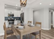 Thumbnail 8 of 27 - Hardwood floored dining room with view of kitchen.