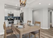 Thumbnail 3 of 24 - Hardwood floored dining room with view of kitchen.