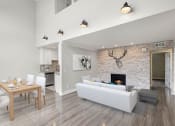 Thumbnail 1 of 29 - Living room with decorative stone wall and view of loft overhead.