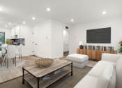 Thumbnail 8 of 25 - Large hardwood floored living room with view to kitchen and hallway storage.