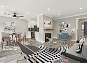 Thumbnail 4 of 15 - Living room with hardwood floors and view of dining room and kitchen.