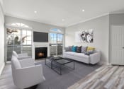 Thumbnail 1 of 20 - Large living room featuring hardwood floors and natural light providing adjacent patio.