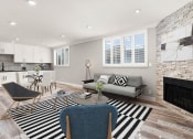 Thumbnail 3 of 19 - Hardwood floored living room with large windows and stone-accented fireplace.