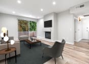 Thumbnail 3 of 22 - Living Room with hardwood floors, fireplace, and direct patio access.