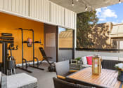 Thumbnail 13 of 20 - On-site fitness center with weight equipment and view of lounge.