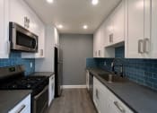 Thumbnail 12 of 29 - Brand new kitchen cabinets, back splash, quartz stone counter tops, and stainless steel appliances with fridge!