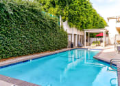Thumbnail 14 of 23 - Community pool and lounging area at Woodridge Apartments.