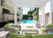 Thumbnail 15 of 23 - Community pool and lounging area at Woodridge Apartments.