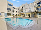Thumbnail 17 of 24 - Gorgeous courtyard pool and lounging space at Clarington Court Apartments