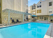Thumbnail 19 of 27 - Courtyard pool with lounging and picnic space