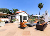 Thumbnail 11 of 23 - Open air rooftop patio with gas firepit, BBQs, several seating locations, and cable television.