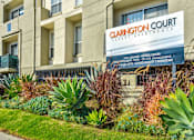Thumbnail 22 of 24 - a building with a sign in front of a garden