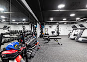 Thumbnail 16 of 31 - Fitness center Including cycling bikes, ellipticals, treadmills, free weights, and stretching balls.
