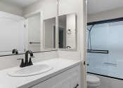 Thumbnail 11 of 27 - Modern styled bathroom with shower and tub.