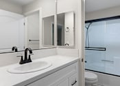 Thumbnail 13 of 24 - Modern styled bathroom with shower and tub.