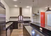 Thumbnail 31 of 35 - Apartment kitchen with industrial feel vent hood at The Mosaic on Broadway, San Antonio, TX, 78215