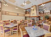 Thumbnail 14 of 50 - A dining room with tables and chairs and a clock on the wall.