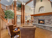 Thumbnail 10 of 50 - A living room with a fireplace and a staircase.