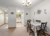 Thumbnail 15 of 27 - A dining room with a table set for four.