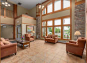 Thumbnail 9 of 50 - A living room with a couch, chairs, and a coffee table.
