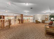 Thumbnail 11 of 50 - A large room with a carpeted floor and furniture.