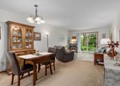Thumbnail 21 of 27 - A dining room with a wooden table and chairs.