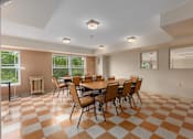 Thumbnail 15 of 50 - A room with a checkered floor and a table with chairs.