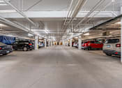 Thumbnail 19 of 50 - A spacious parking garage with multiple cars parked.