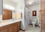 Thumbnail 27 of 27 - A bathroom with a toilet, sink, and shower.