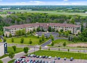 Thumbnail 4 of 50 - A large building with a parking lot in front of it.