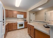 Thumbnail 23 of 50 - A kitchen with wooden cabinets and a white refrigerator.