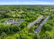 Thumbnail 11 of 27 - A bird's eye view of a residential area with houses and trees.