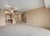 Thumbnail 30 of 50 - A spacious room with a ceiling fan and carpeted floor.