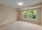 Thumbnail 45 of 50 - A room with a window and a carpeted floor.