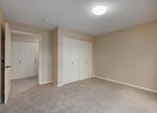Thumbnail 49 of 50 - A room with a carpeted floor and two white doors.