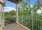 Thumbnail 46 of 50 - A balcony with a white railing and a flag hanging on the wall.