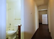 Thumbnail 7 of 7 - a bathroom with a toilet and a sink and a refrigerator