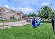 Thumbnail 37 of 41 - A playground with a blue slide and a baseball diamond.