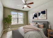 Thumbnail 9 of 33 - a bedroom with a large bed and a ceiling fan