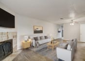 Thumbnail 2 of 23 - a living room with a couch and a table and a fireplace