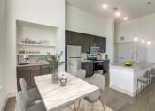 Thumbnail 2 of 44 - an open kitchen and dining room with a table and chairs