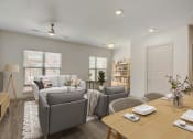 Thumbnail 2 of 37 - a living room and dining room with couches and a table