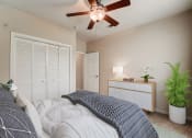 Thumbnail 10 of 42 - a bedroom with a ceiling fan and a bed