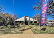 Thumbnail 18 of 42 - the front of a building with a purple and pink flag