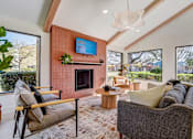 Thumbnail 24 of 42 - a living room with a couch and a fireplace