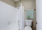 Thumbnail 8 of 21 - a small bathroom with a toilet and a shower