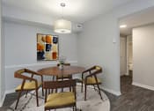 Thumbnail 6 of 13 - A dining room with a round table and chairs.