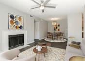 Thumbnail 5 of 13 - A living room with a fireplace, a dining table, and chairs.