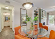 Thumbnail 4 of 44 - a dining room with orange chairs and a glass table